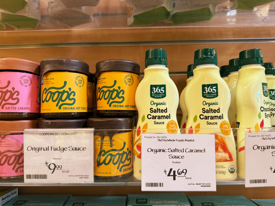 365 Organic Salted Caramel Sauce displayed beside specialty dessert toppings with a $4.69 price tag.