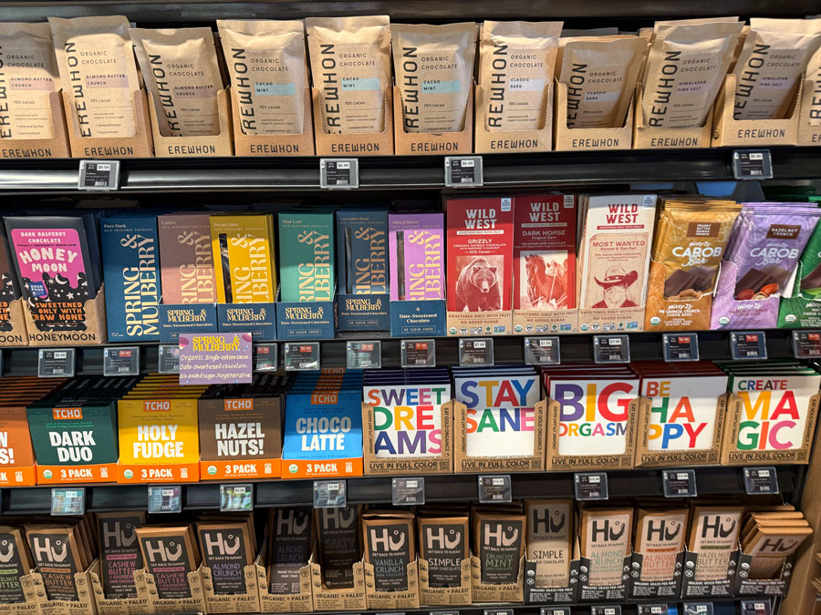 Erewhon organic chocolate bars alongside Spring & Mulberry and other brands.
