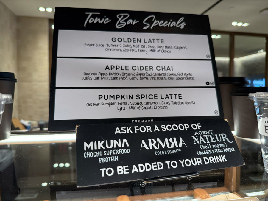 Erewhon Tonic Bar menu featuring Pumpkin Spice Latte, Apple Cider Chai, and Golden Latte.
